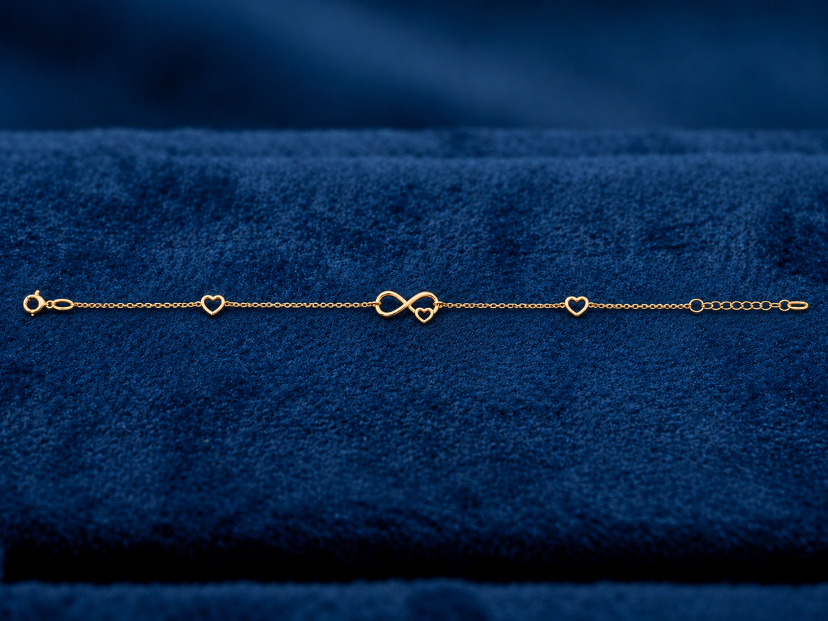 Bracelet symbole infini en or 18 carats dans un écrin en velours bleu.