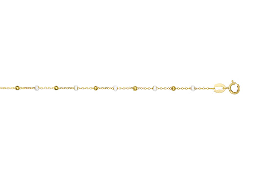 Bracelet style Gigi Clozeau en or 18 carats avec des boules de résine blanche.