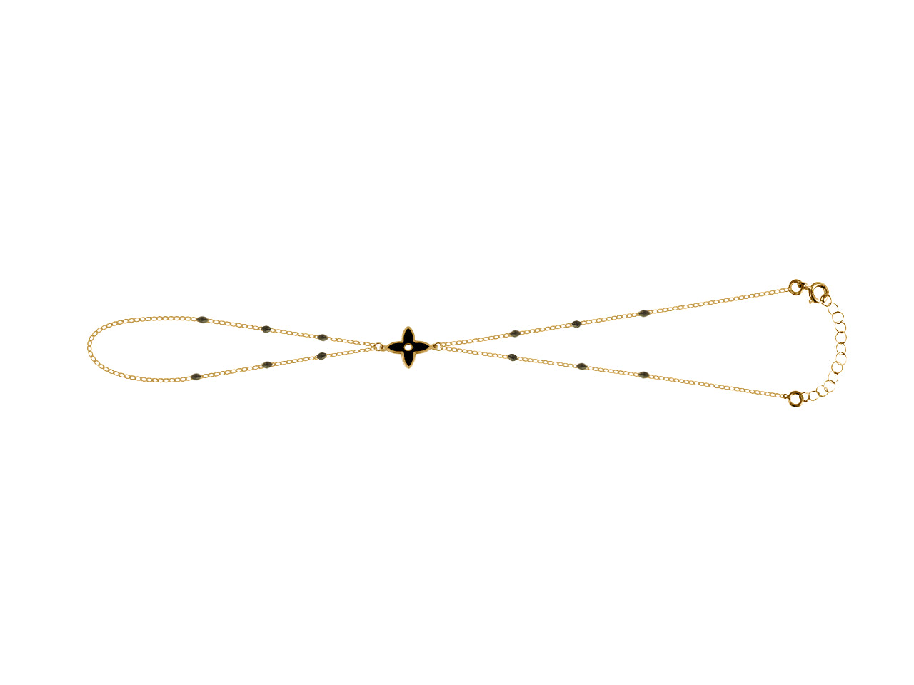 Chaîne de main en or jaune 18 carats avec motif fleur et résine noire portée sur main femme