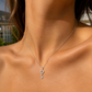 Femme portant un collier avec une clef en or blanc 18 carats (or gris) et diamants, un bijou de peau élégant et raffiné.