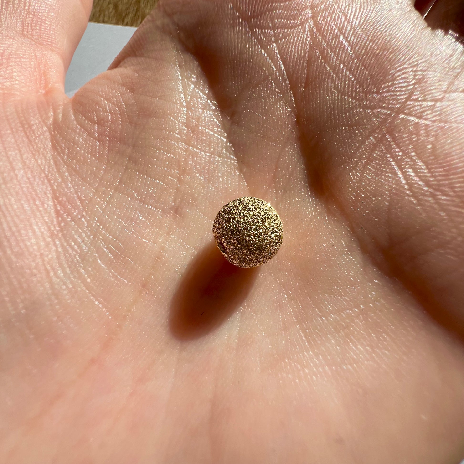 Perle d'or granitée à 2 trous en or jaune 18 carats pour la création de bracelets.