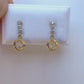 Boucles d'oreilles pendantes en or jaune 18 carats, design cercle évidé serti d'oxydes de zirconium qui scintillent au soleil