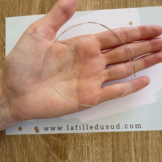 Aperçu en vidéo de la souplesse du fil d'or rond 0,50 mm en or gris 18 carats dans la paume de la main.